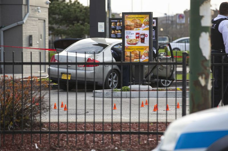 日曜日の午後、マクドナルドの駐車場で砲弾のケーシングが散らばっています。そこでは、7歳の少女が射殺され、ドライブスルーで待っている間に父親が重傷を負いました。