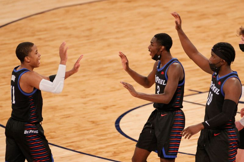 DePauls Charlie Moore, venstre, high-fives holdkammeraterne Kobe Elvis og Ray Salnave i anden halvdel af deres kamp mod Providence. De Blå Dæmoner vandt 70-62.