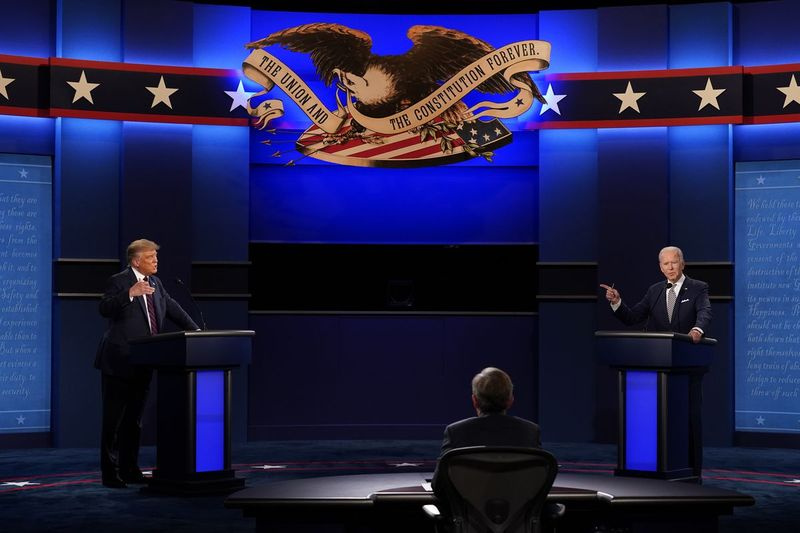 Predsednik Donald Trump, levo, in demokratski predsedniški kandidat, nekdanji podpredsednik Joe Biden, desno, z moderatorjem Chrisom Wallaceom, na sredini, Fox News med prvo predsedniško razpravo v torek, 29. septembra 2020, na univerzi Case Western in kliniki Cleveland, v Cleveland, Ohio.