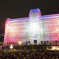 Pirmoji „Art on the Mart“ paroda Čikagos upės take. Skaitmeninė viešoji meno instaliacija, projektuojama Merchandise Mart pastato šone. | Rickas Majewskis „Saulėlaikiams“.