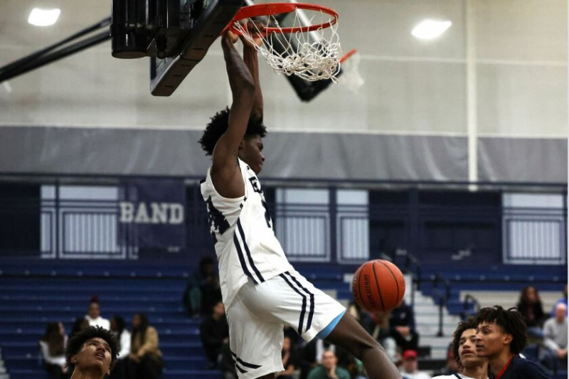  Ο Mekhi Lowery (24) του Oswego East δέχεται φάουλ κατά την άνοδο, αλλά εξακολουθεί να τελειώνει το dunk του με στυλ.