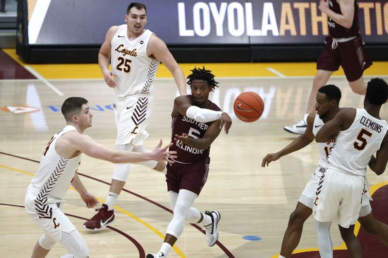 Southern Illinois Guard Lance Jones, Center, leitet den Ball durch Loyola-Verteidiger.