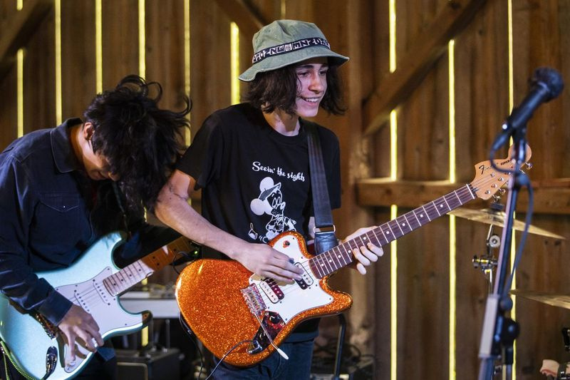 Rylan Wilder og den floppy hatten hans leker med Monarchy Over Monday under tenårings Chicago-bandets comeback-opptreden på musikkfestivalen Postock nær Albany, Wisconsin, 30. juli.