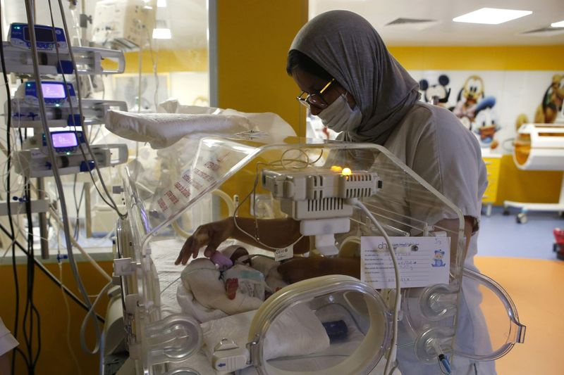 Marocká zdravotná sestra sa v stredu 5. mája 2021 stará o jedno z deviatich bábätiek chránených v inkubátore na pôrodnici súkromnej kliniky Ain Borja v marockom Casablance.