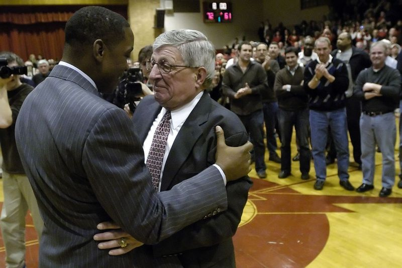 Bývalá hviezda St. Joseph a NBA Isiah Thomas objíma trénera Genea Pingatoreho počas oslavy v roku 2009.
