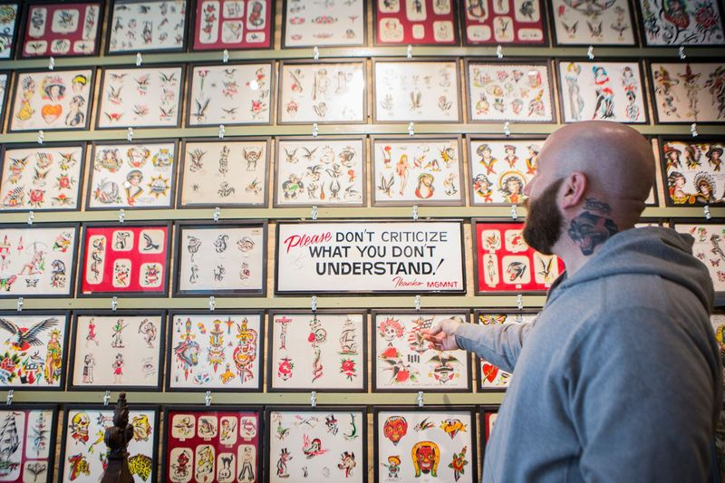 Nick Colella seina ees 20. sajandi keskpaigast pärit vintage välklambi seina ees, mis on segatud kaasaegsete piltidega, mille on loonud kunstnikud, kes töötasid Chicagos Great Lakes Tattoo juures, kolmapäeval, 9. märtsil 2016. Välk on näide pildist, mida kunstnik saab kasutada tee i