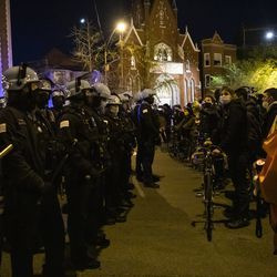 Policjanci i protestujący z Chicago rozstawiają się na Logan Square po tym, jak ponad tysiąc osób przemaszerowało po dzielnicy West Side, aby zaprotestować przeciwko śmiertelnej strzelaninie 13-letniego Adama Toledo w piątek wieczorem 16 kwietnia 2021 r.