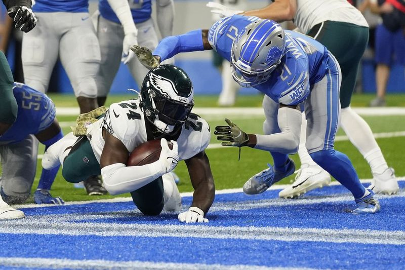O running back dos Eagles, Jordan Howard, cai na end zone para uma corrida de touchdown de 4 jardas enquanto o segurança livre do Lions, Tracy Walker III, defende.