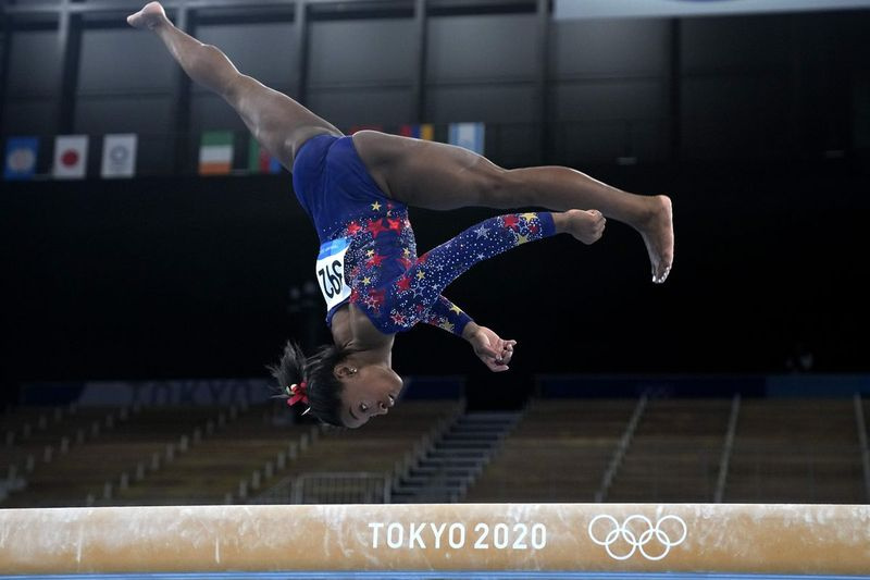 米国のシモーネ・バイルズは、東京オリンピックでの女性の体操競技の予選で平均台で演奏します。