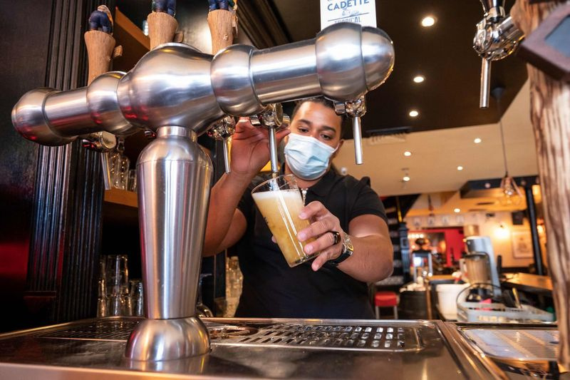 El dueño de un restaurante prueba la bomba de cerveza en su restaurante en París la semana pasada.